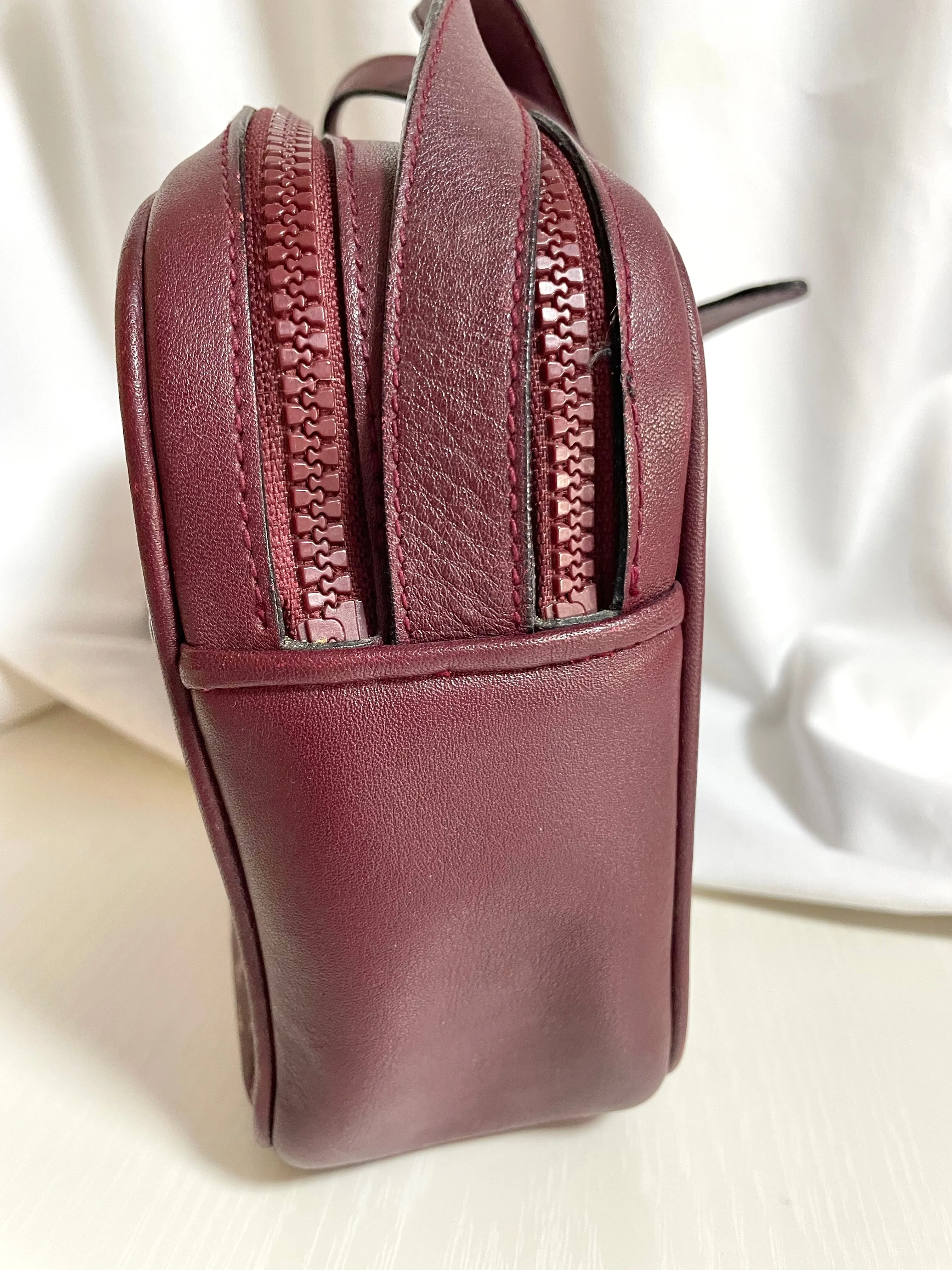 1980s. vintage Celine shoulder purse in bordeaux, burgundy leather with iconic blaison macadam print all over. riri zipper. 0411102
