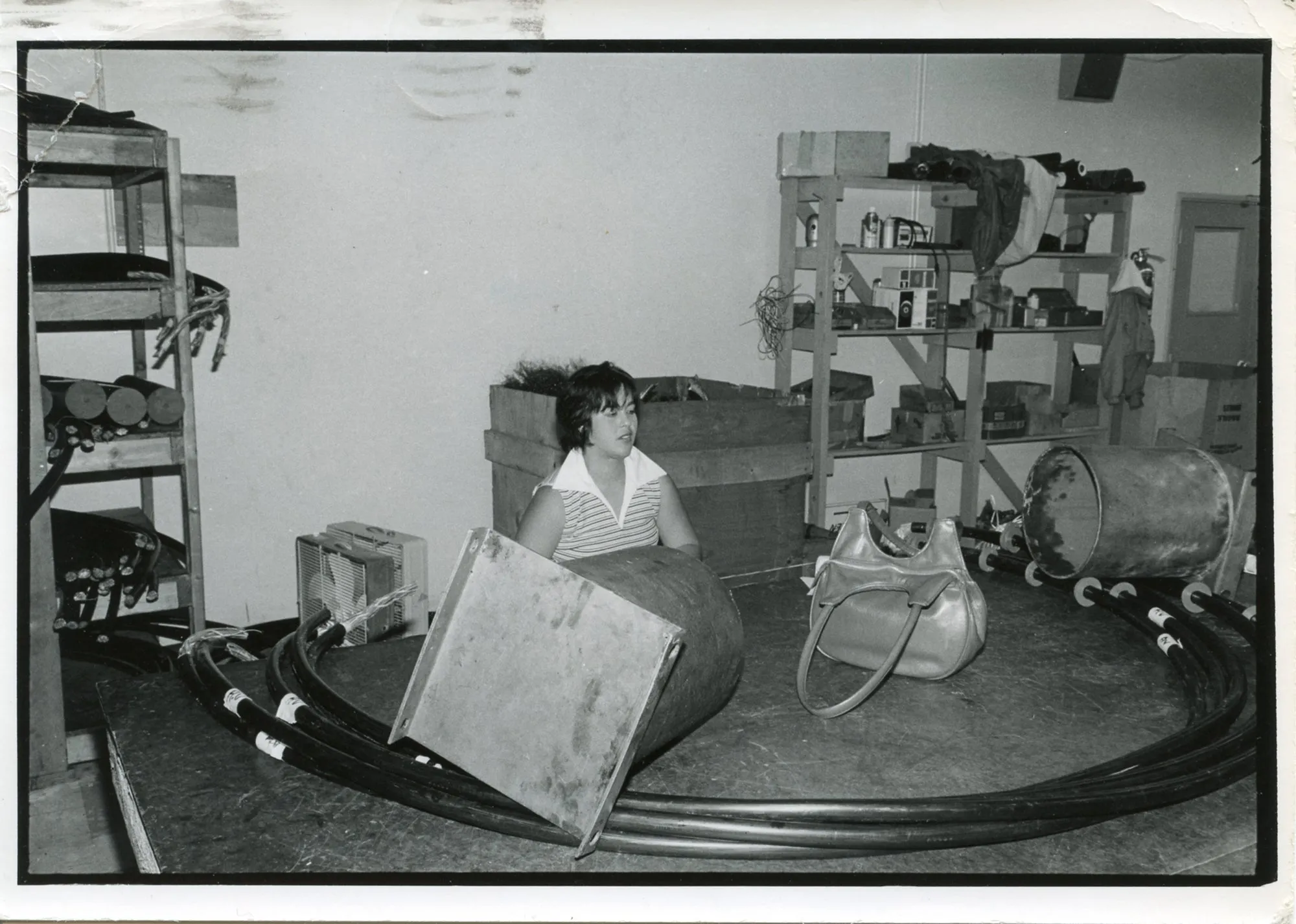 Untitled, L.A. [woman in workshop with oversized handbag on table]