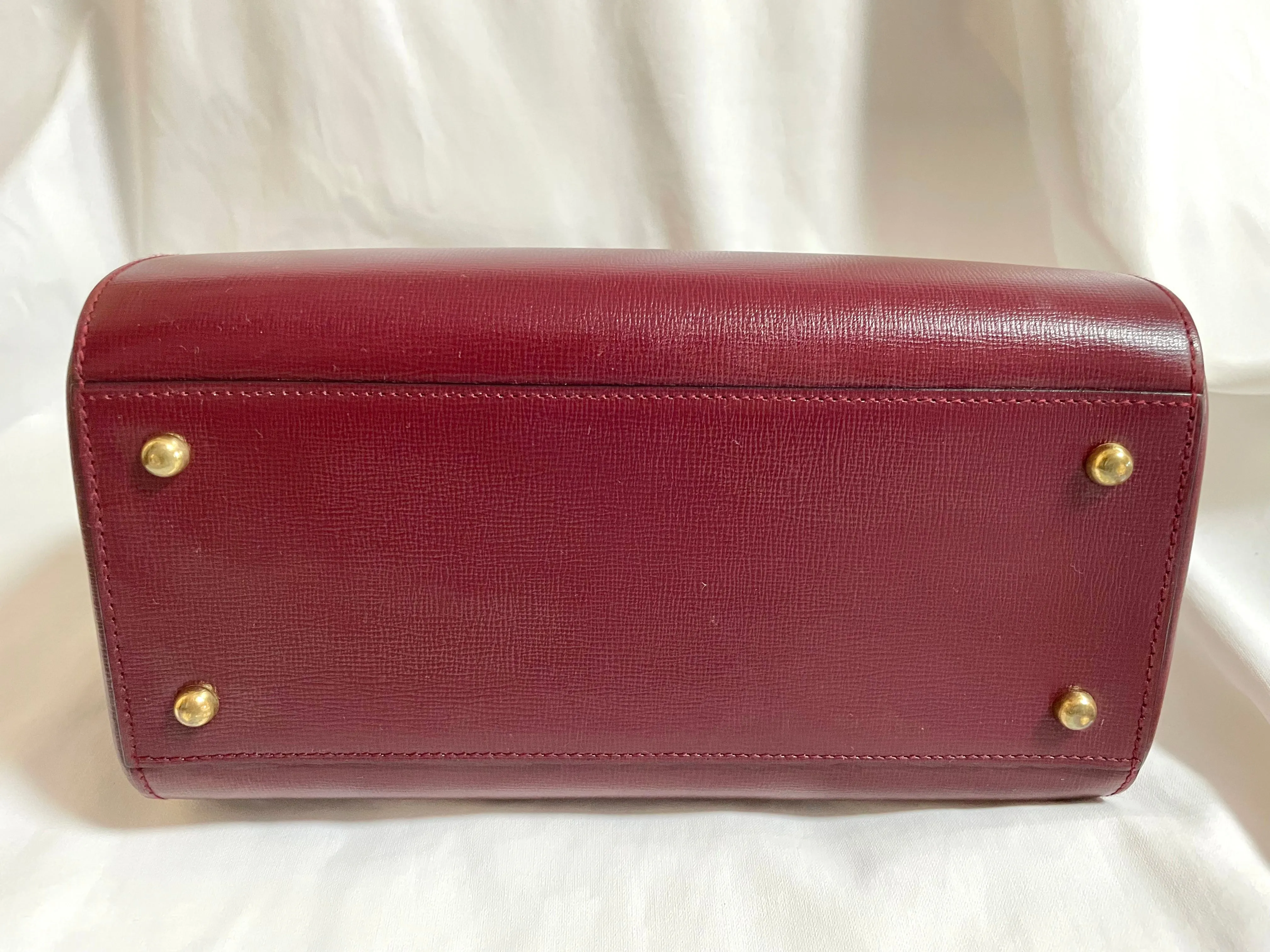 Vintage Cartier classic wine, bordeaux leather handbag purse with bullet design gold hardware at handles. Must de Cartier. 0408171