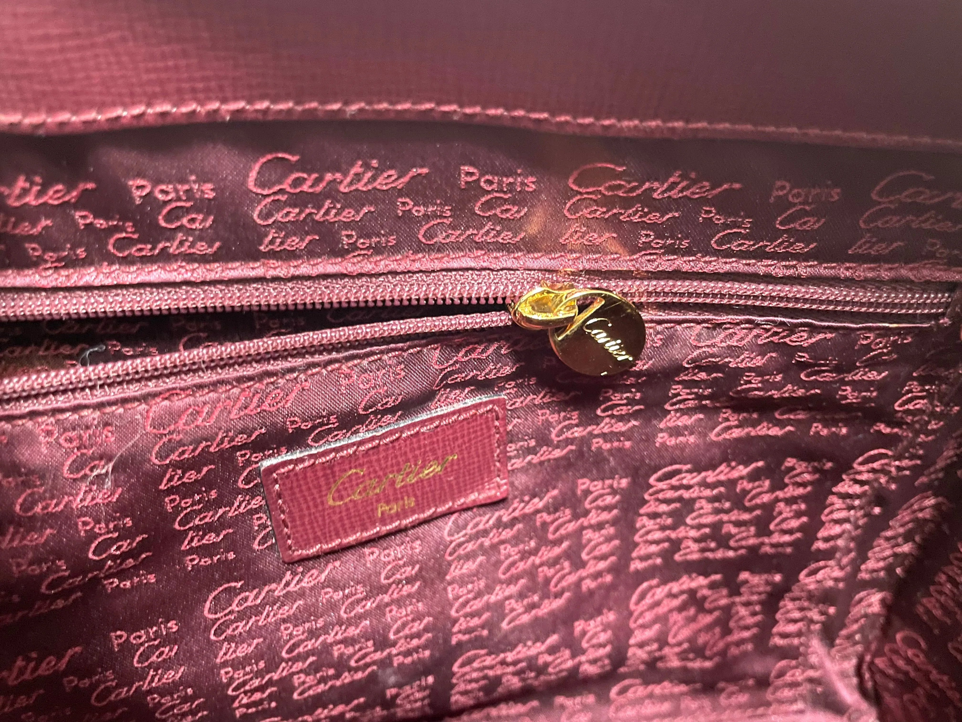 Vintage Cartier classic wine, bordeaux leather handbag purse with bullet design gold hardware at handles. Must de Cartier. 0408171