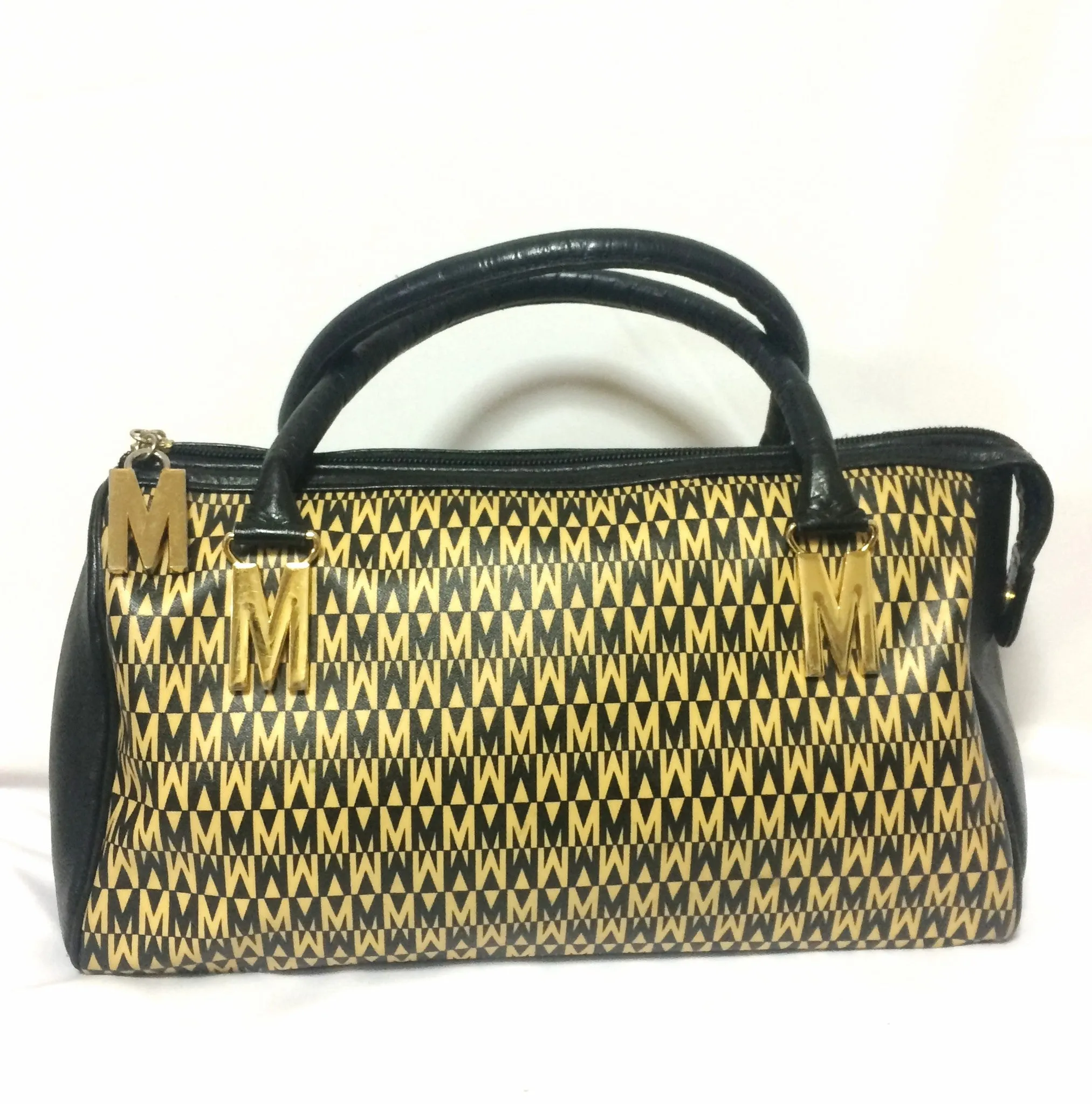 Vintage MOSCHINO black and ivory beige logo M print handbag, mini duffle bag with leather trimmings and golden M charms. 060521re1