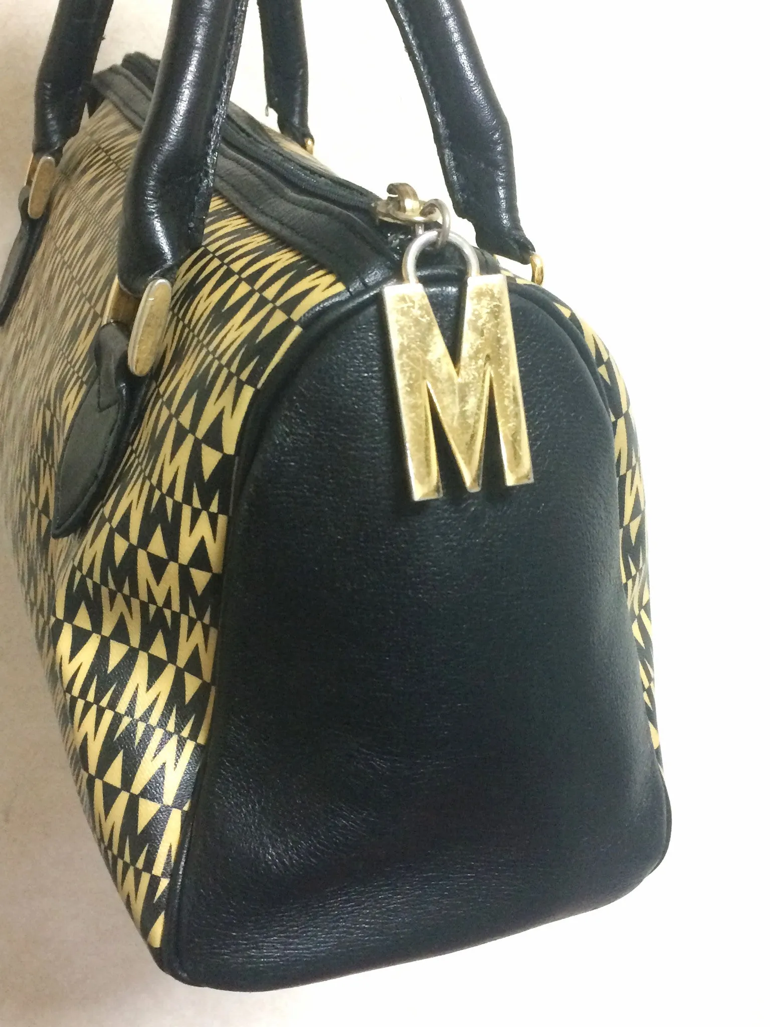 Vintage MOSCHINO black and ivory beige logo M print handbag, mini duffle bag with leather trimmings and golden M charms. 060521re1