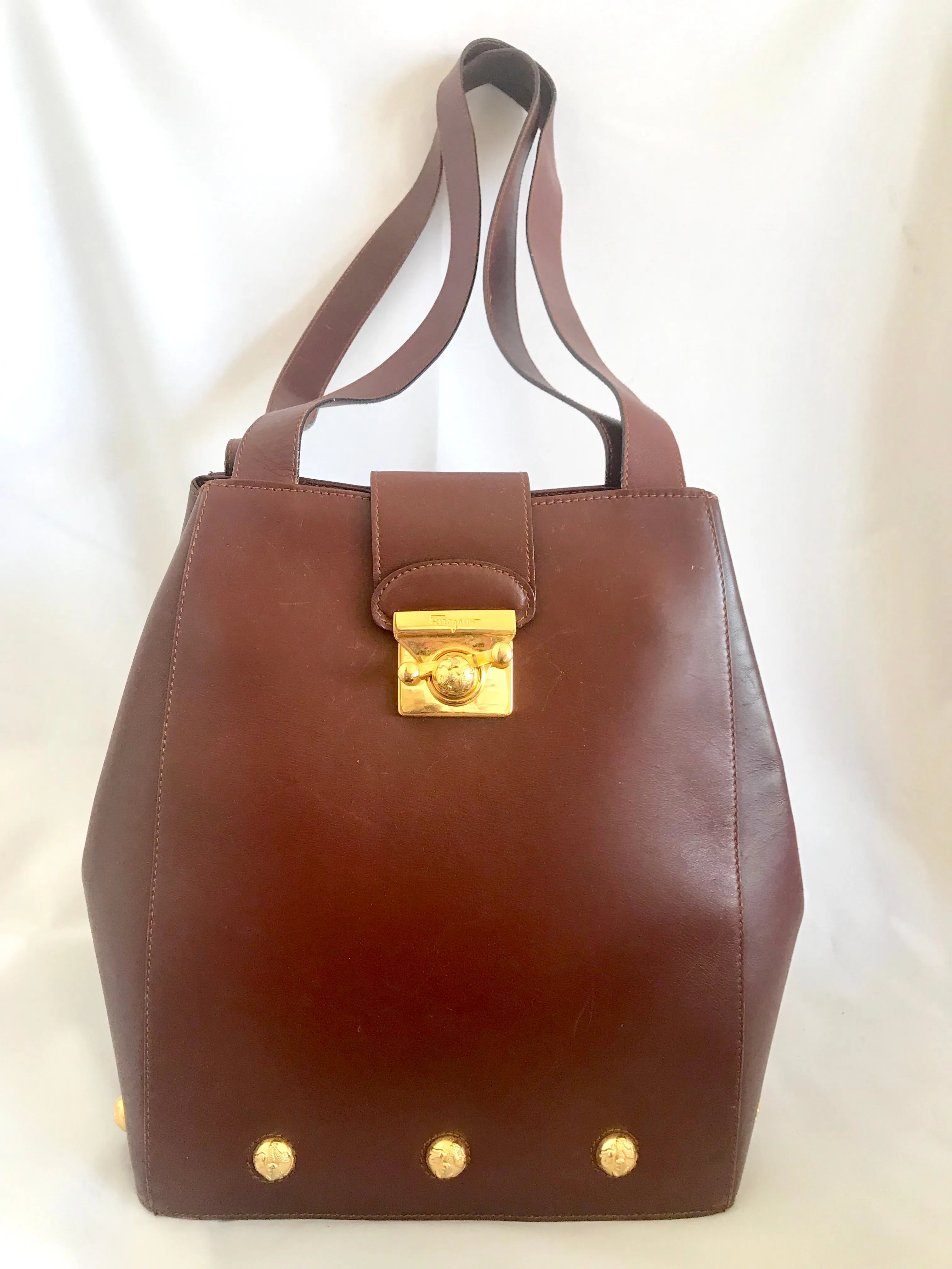 Vintage Salvatore Ferragamo brown leather purse with gold tone elegant closure. Featuring Ferragamo charms. 060516re4