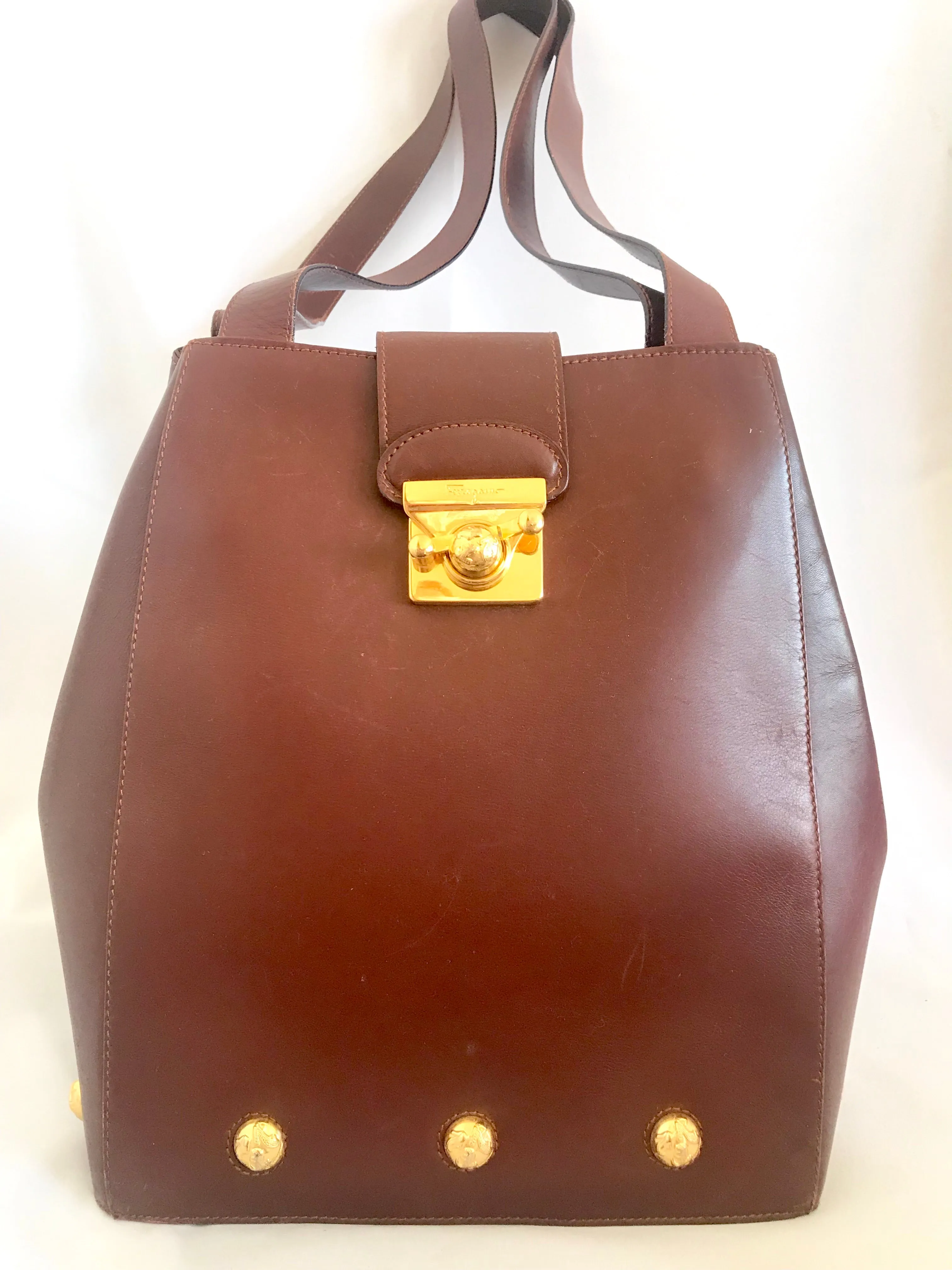 Vintage Salvatore Ferragamo brown leather purse with gold tone elegant closure. Featuring Ferragamo charms. 060516re4