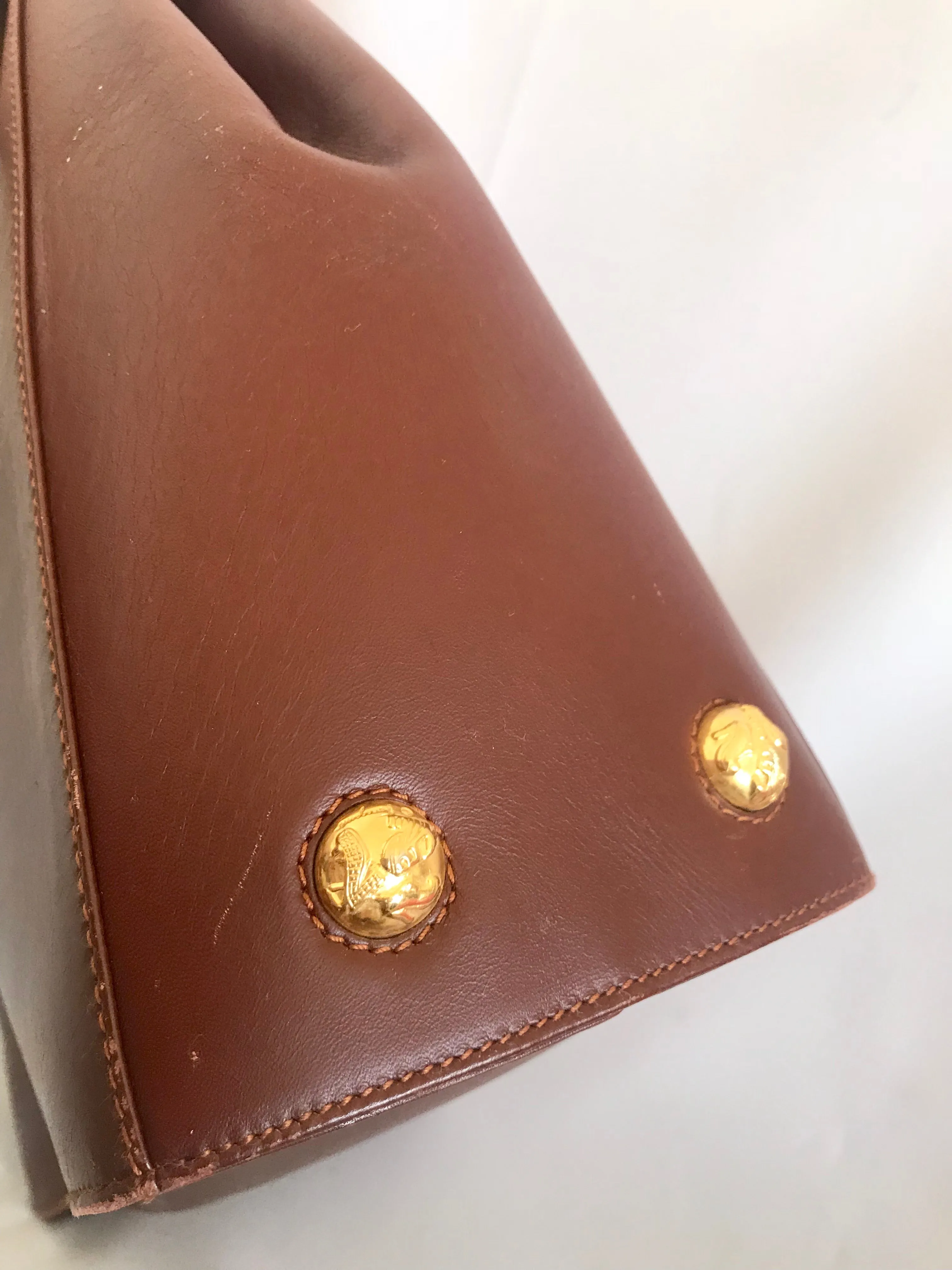 Vintage Salvatore Ferragamo brown leather purse with gold tone elegant closure. Featuring Ferragamo charms. 060516re4