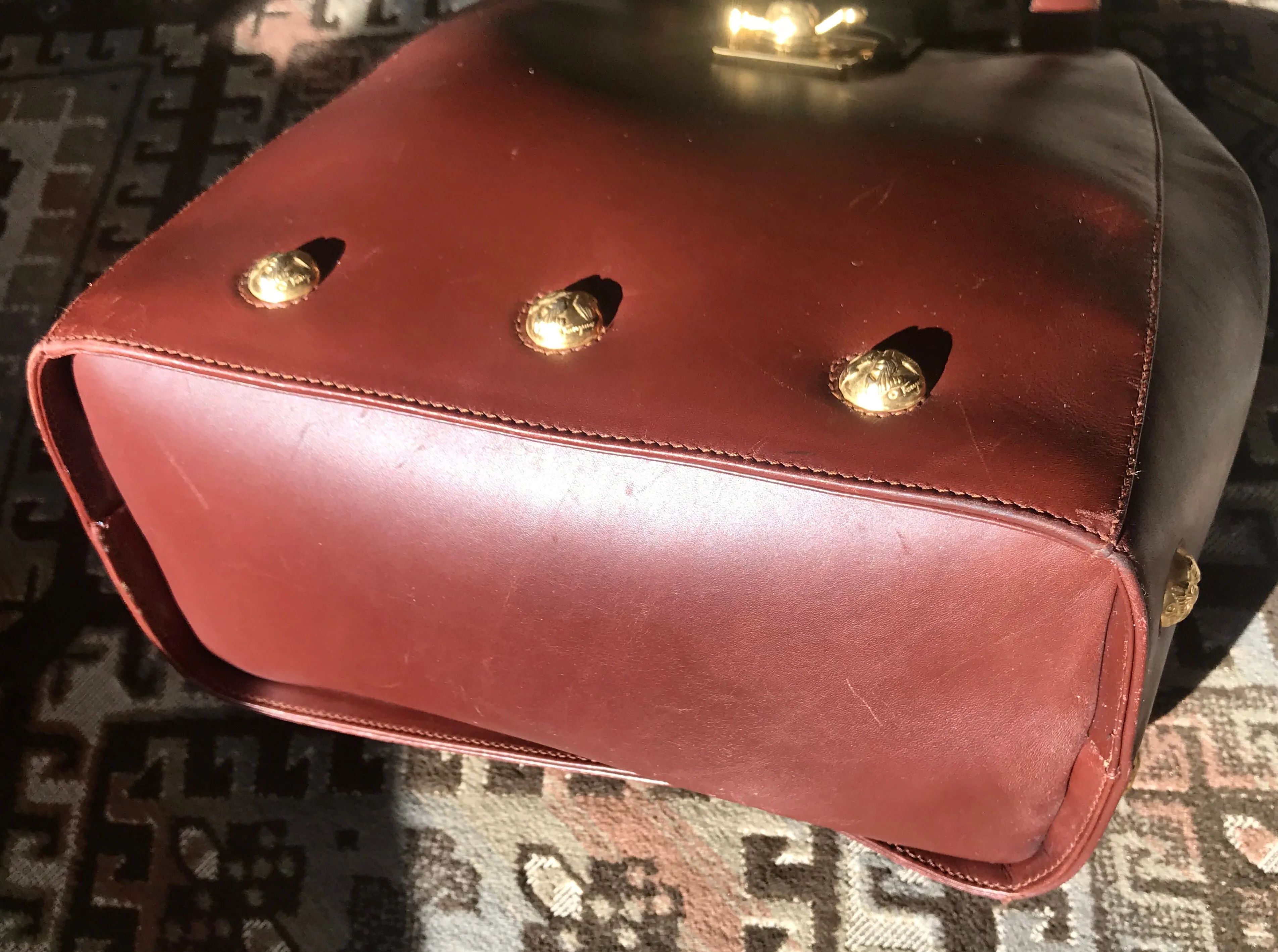 Vintage Salvatore Ferragamo brown leather purse with gold tone elegant closure. Featuring Ferragamo charms. 060516re4